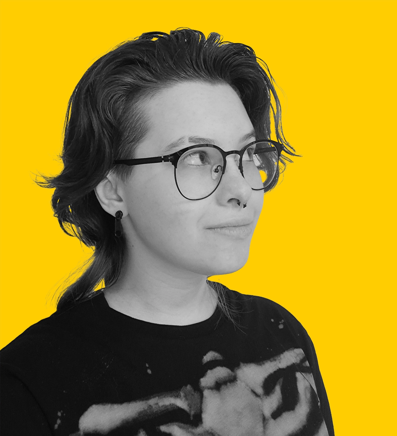 Monochrome photo of Nika Korez from the neck up on a yellow background